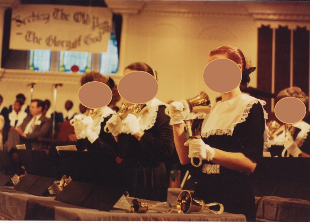 A handbell choir playing at a huuuuge 1988 revival service