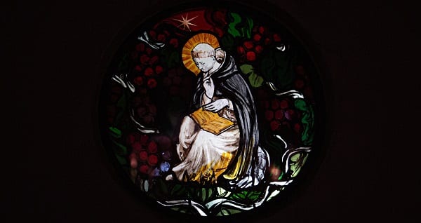 a monk on a stained glass window faces a reckoning