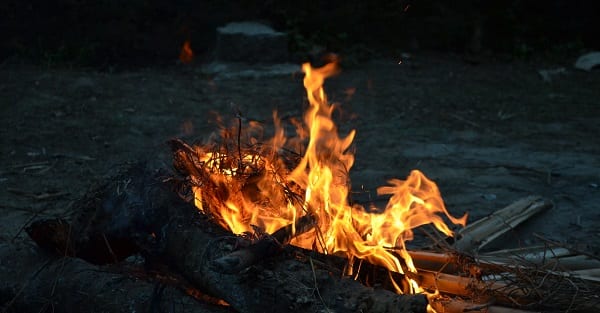 a small fire burns in a firepit