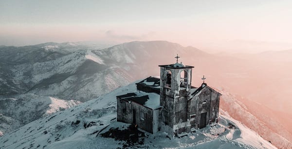 very old church atop a snowy hill