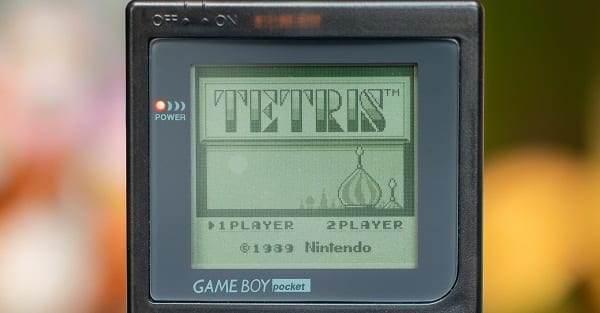a nintendo game boy displaying a tetris game