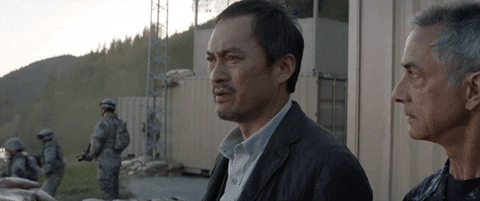 Meme gif of Asian guy saying "Let them fight," from the godzilla movie I think.